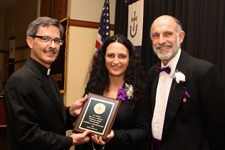 From left, Kevin P. Quinn, S.J., president of The University of Scranton, presents the Alpha Sigma Nu Teacher of the Year Award to Vanessa Silla-Zaleski Talarico, Ed.D., of the University’s Education Department, with Alpha Sigma Nu moderator Thomas Hogan, Ph.D., professor of psychology.